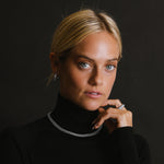 A Curb Chain Choker with Diamond Clasp by Sheryl Lowe pictured on a model wearing a black sweater.