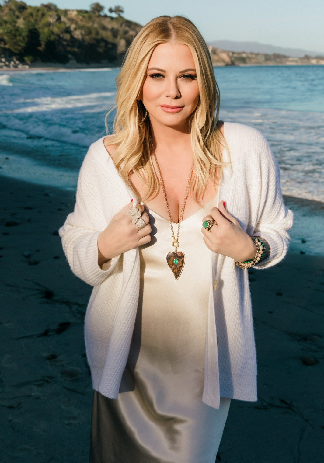 On a Montecito beach, Sheryl Berkoff Lowe models a necklace, bracelets, earrings and rings from her line of women's jewelry.